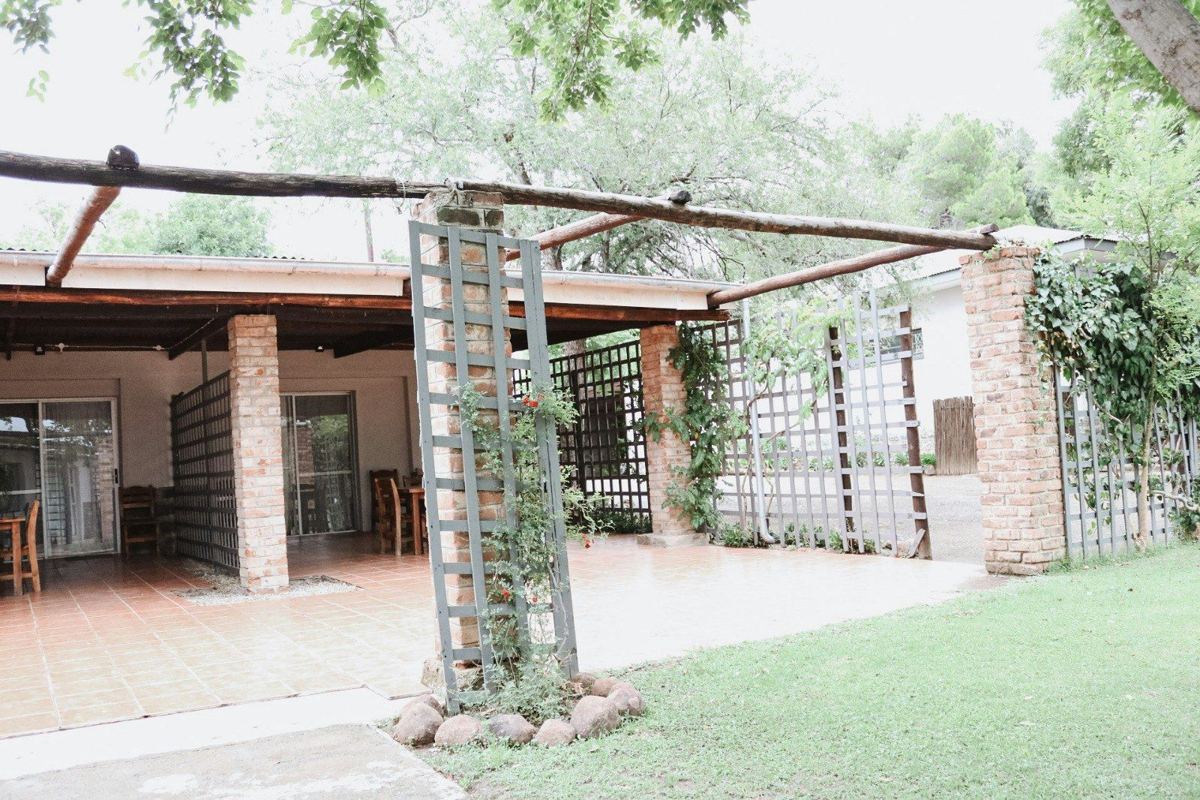 Covered patio with vine-covered pillars